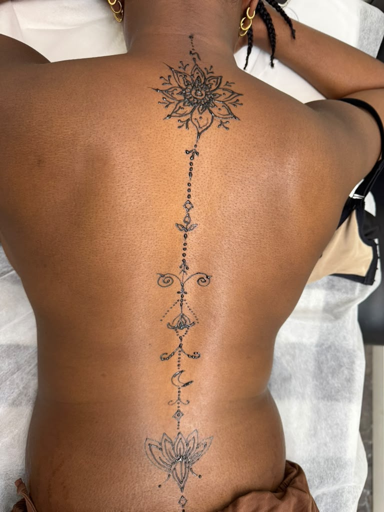Spine mandala and lotus henna tattoo down the back — bridal-style mehndi at Magical Waxing Atlanta