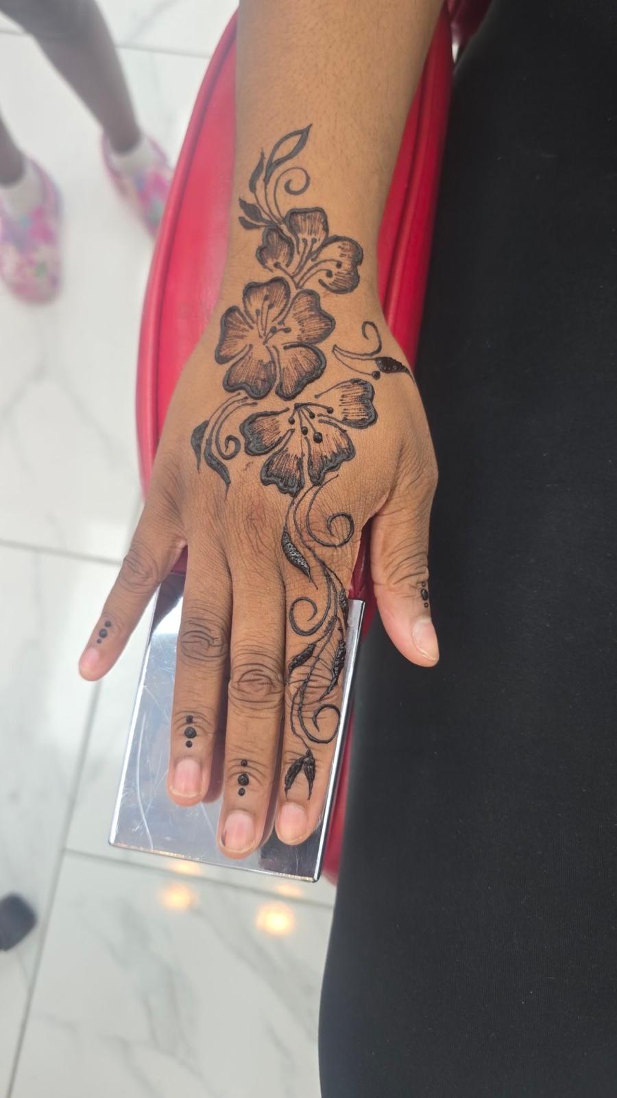 Fresh hibiscus flower henna design on hand and fingers — Magical Waxing Atlanta mehndi artist